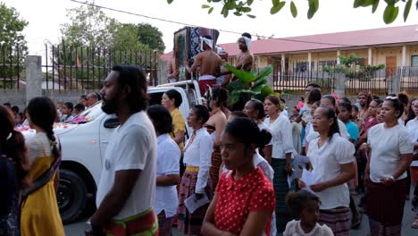 A-religion-parade-and-crowds-of-Timorese-people-on-the-streets-of-Dili,-Timor-Leste,-with-a-religious-catholic-statue