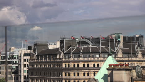 Union-Jack-Flags-blowing-in-wind-on-top-of-building