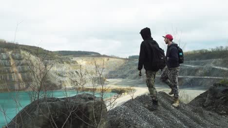 Two-young-men-observing-the-natural-beauty-of-a-lake-in-a-quarry-in-the-town-of-Eisborn-in-Germany