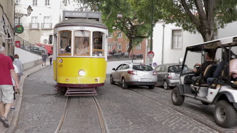 Electrico-tram-cruising-trough-the-streets-of-Lisbon-front-tracking-shot-slow-motion