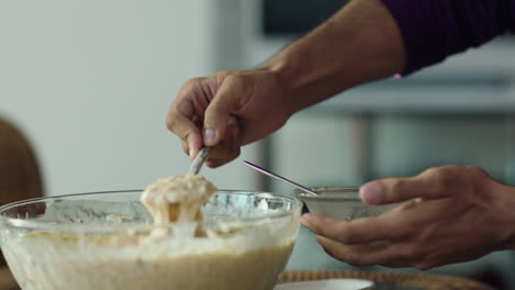 A-close-up-slow-mo-view-of-a-male-hands-serving-the-sweets-from-the-bowl