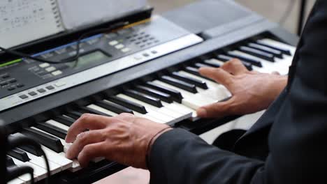 male-hands-playing-the-piano