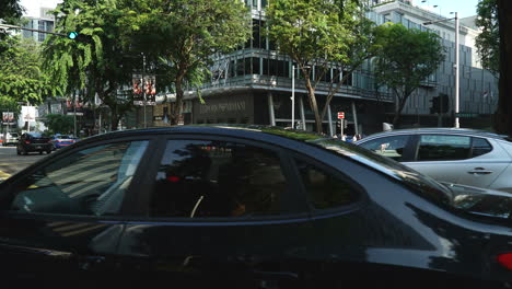 Singapore---Circa-Slow-panning-shot-of-sped-up-traffic-at-busy-intersection-in-Orchard-road,-Singapore