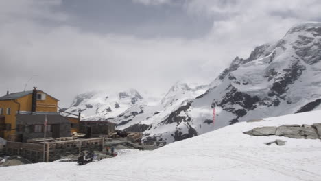 Pan-Shot-of-Mountain-hut-in-the-middle-of-the-glacier-area-surrounded-by-the-Zermatt
