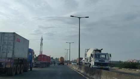a-view-of-highway-road-to-minjur-which-has-lorry-and-heavy-duty-vehicles-parked-on-either-side-of-roads