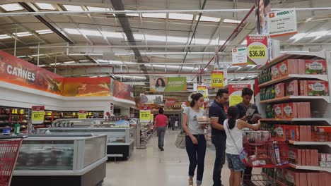 Walking-through-the-aisles-of-the-supermarket-and-people-deciding-what-to-buy