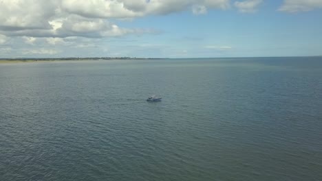Aerial-view,-4k-panning-shots-of-a-boat-along-the-coastline