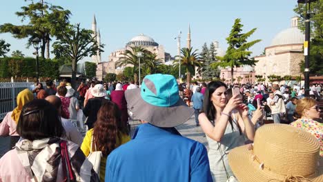 Unidentfied-people-walk-at-Sultanahmet-Park-where-Blue-Mosque-or-Sultan-Ahmet-Mosque-and-Hagia-Sophia-located-in-Istanbul,-Turkey