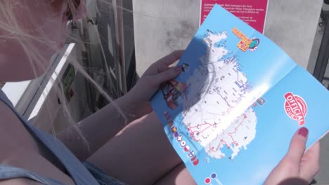A-female-tourist-looking-at-the-map-of-Malta-circa-2019