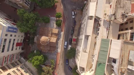 aerial-drone-top-shots-of-urban-Athens-small-road-traffic-park-capital-of-Greece-sunny-day-old-church-establishment-generic-shot