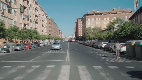 Pedestrian-people-crossing-street-at-major-avenue-in-Seville,-Spain