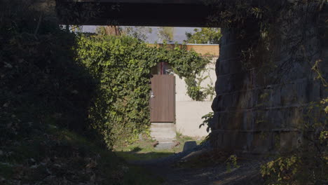 Beautiful-mysterious-door-gate-under-bridge-4k