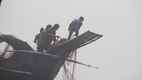 Bangladeshi-fishermen-pulling-nets-from-the-river-water