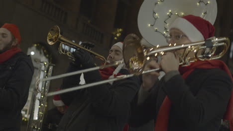 Street-musicians-dressed-like-Santa-Claus-plays-on-trumpets