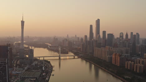 Fly-over-Alibaba-Group-Guangzhou-headquarters-construction-site-at-epic-golden-sunset
