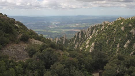 Flying-Close-to-Green-Mountain-Range-at-Montserrat,-Catalonia,-Spain,-Aerial