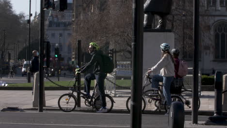 Cyclists-Waiting-By-Traffic-Lights-On-Folding-Bike-On-Great-George-Street-In-Westminster