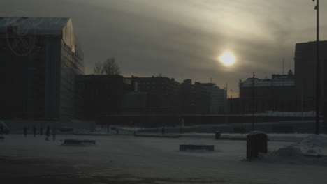Kansalaistori-Square-in-Helsinki-at-cold-and-snowy-winter-day-with-a-sun-shining-through-the-clouds