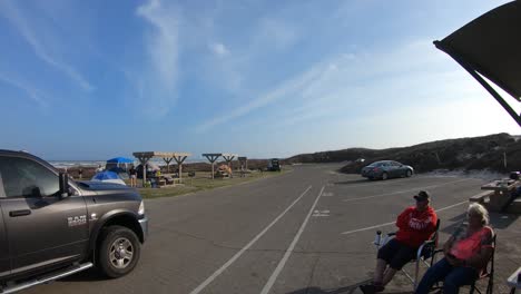 time-lapse-of-family-putting-up-a-tent-and-a-couple-enjoying-the-sun-at-Maliquite-Campground-at-North-Padre-National-Seashore