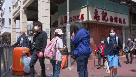 Pedestrians-walk-past-a-closed-restaurant-in-Hong-Kong