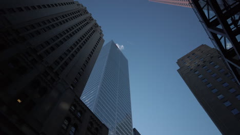 Wide-rotating-shot-looking-upwards-at-skyscrapers-and-the-blue-limitless-sky