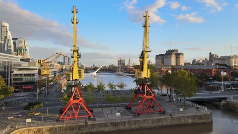Aerial-of-port-cranes-and-famous-bridge-at-Puerto-Madero,-Buenos-Aires