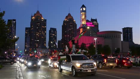 Demonstrators-waving-Palestinian-flags-standing-on-cars-at-dusk-during-the-peaceful-pro-Palestinian-rally-in-Mississauga-to-create-international-awareness-of-Israel–Palestine-conflict