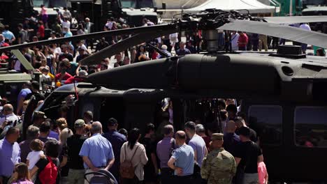 Helicopter-surrounded-by-people-on-a-military-exhibition-in-Tirana,-Albania