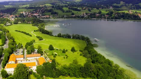 Beautiful-bavarian-Tegernsee---Aerial-view-of-a-moored-ship-at-Gmund-and-the-restaurant-Gut-Kaltenbrunn-in-the-foreground-at-a-beautiful-summer-day