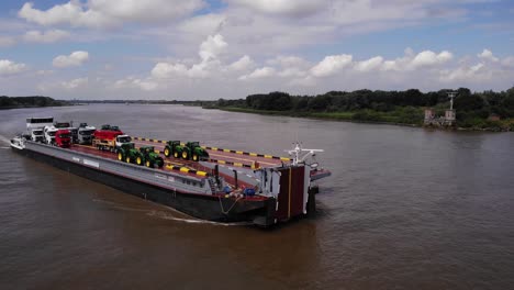 Aerial-View-Of-Dynamica-Barge-Transporting-Lorries-And-Tractors-Along-Oude-Maas-Near-Barendrecht