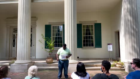 African-American-tour-guide-talks-with-guests-at-The-Hermitage,-home-of-Andrew-Jackson,-7th-President-of-USA