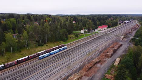 Aerial-tracking-drone-view-of-historical-DM7-passenger-train-also-known-as-"Lättähattu"-departing-from-Haapamäki-railway-station