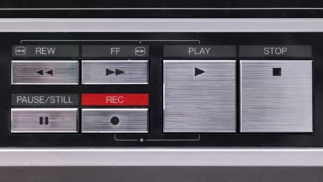 Extreme-close-up-of-buttons-on-an-old-antique-or-vintage-VCR-Pushing-Fast-forward