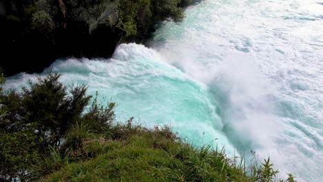 Looking-at-stunning-Huka-Falls-waterfall-mouth-with-extremely-fast-flowing-water-from-Waikato-River-on-a-short-walk-in-Taupo,-New-Zealand-Aotearoa