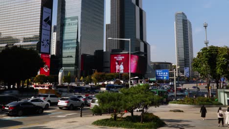 Busy-street-Traffic-on-Yeongdong-daero-road-and-people-walking-near-Samseong-station-Coex-World-Trade-Center-Seoul-,-South-Korea-daytime-panning-time-lapse