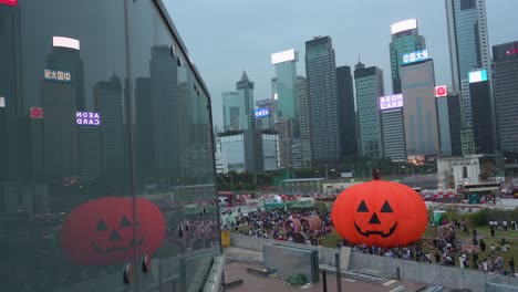 A-giant-10-meter-tall-inflatable-Halloween-pumpkin-installation-is-enjoyed-by-the-public-during-Halloween-celebrations-as-skyscrapers-are-seen-in-the-background-in-Hong-Kong