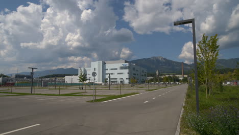 Wide-shot-of-empty-parking-area-on-Biogen-Factory-in-Switzerland-during-sunny-day---Research-of-modern-medicine,-Neuroscience,Alzheimer-Disease,Multiple-Sclerosis-and-Parkinson