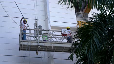 Workers-painting-a-HDB-facade-in-Singapore