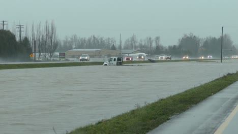 A-truck-drowns-in-water-in-between-highways-on-a-rainy-day