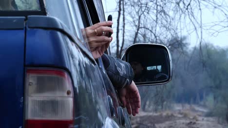 Female-Hands-Holding-Smartphone-Taking-Picture-Out-Of-Truck-Window