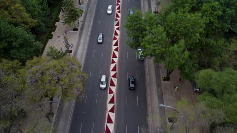 Aerial-View-Over-Traffic-in-Paseo-de-la-Reforma-Avenue-with-Poinsettias-Decoration-in-the-Median,-Mexico-City