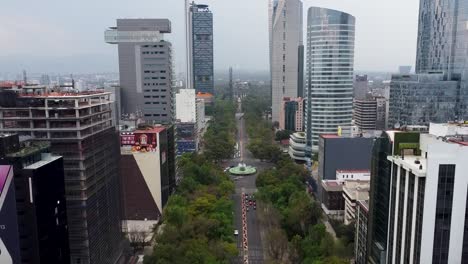 Aerial-View-of-the-Skyscrapers-of-Paseo-de-la-Reforma,-Diana-Cazadora-Roundabout-and-Chapultepec-Castle-in-the-Background,-Mexico-City