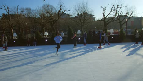 View-of-a-large-crowd-of-the-people-doing-Ice-skating-near-the-Flevopark-on-a-frozen-lake-in-Amsterdam-during-winter-season,-Christmas-in-Netherlands