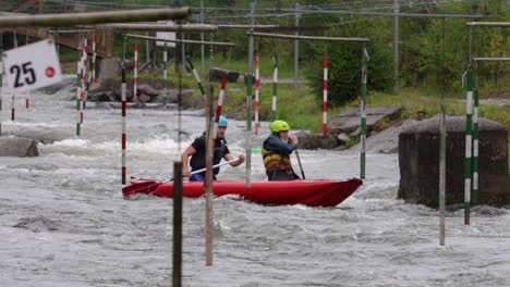 Slow-motion-shot-of-white-water-kayakers-on-a-training-course,-Slovakia
