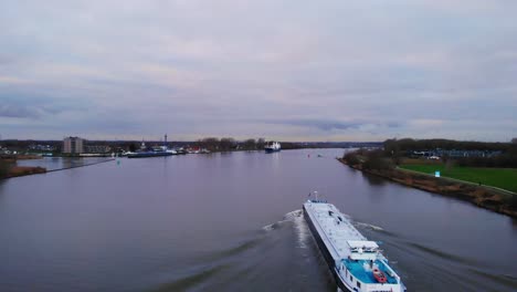 Aerial-View-Over-Inland-Liquid-Tanker-Travelling-Along-Oude-Maas-Through-Zwijndrecht