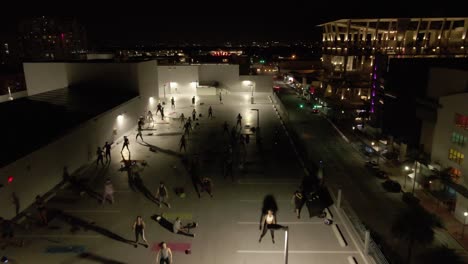 Miami-night-aerial:-Social-distance-Zumba-class-on-rooftop-parking-lot