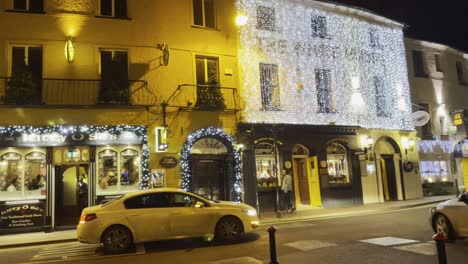 Christmas-time-in-Kinsale-Ireland-during-night-with-bright-decorations,-lights-on-buildings-and-town-vibrancy
