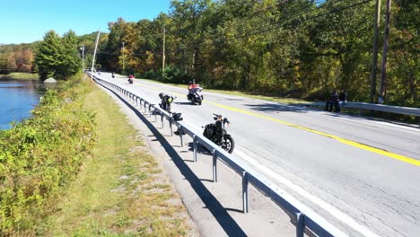Group-of-bikers-travelling-while-two-resting-on-road-side