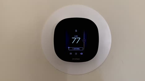 Ecobee-smart-thermostat-installed-on-the-wall-of-home