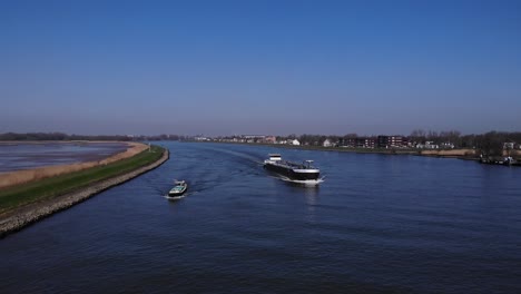Inland-Tanker-And-A-Boat-On-River-Noord-Against-Blue-Sky-In-Netherlands